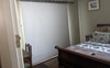A blind blocks the light from the sunroom