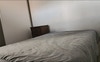 Bedroom with mattress and night table 