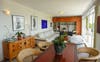 Open plan living spills out onto the balcony