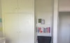 The room has lots of wardrobe space and small desk
