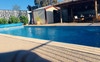 Swimming pool with wicker lounge under Bali Hut 🌞