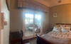 The room with adjoining sunroom view from your bed