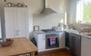 The kitchen gets afternoon sun and tree view.