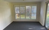 Main room facing large window with shutters