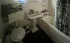 Shared bathroom with shower over bathtub 