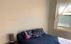 Bed on left wall with space on either side